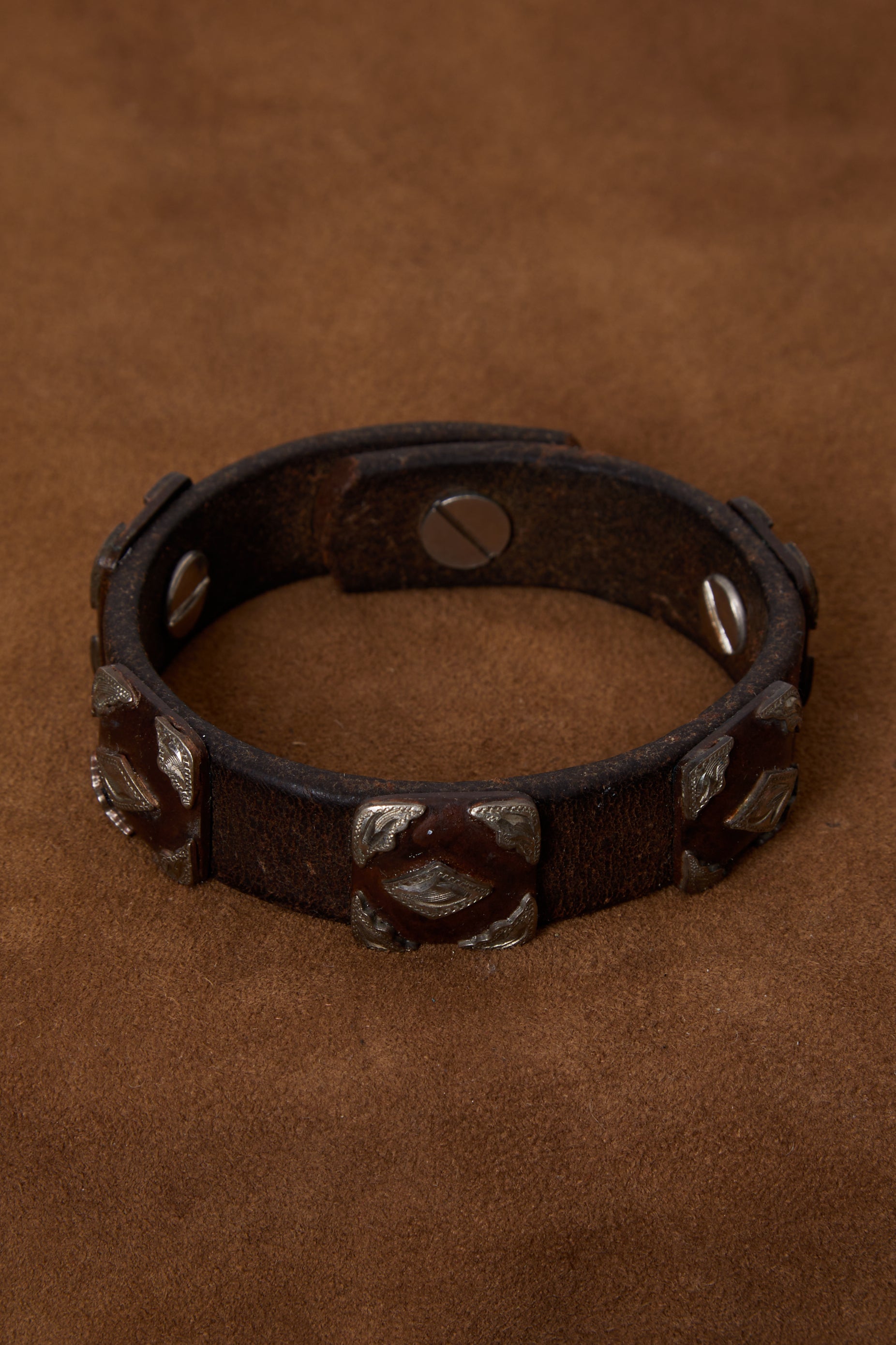 WEATHERED DARK BROWN LEATHER AND ORNATE SILVER BRACELET CUFF