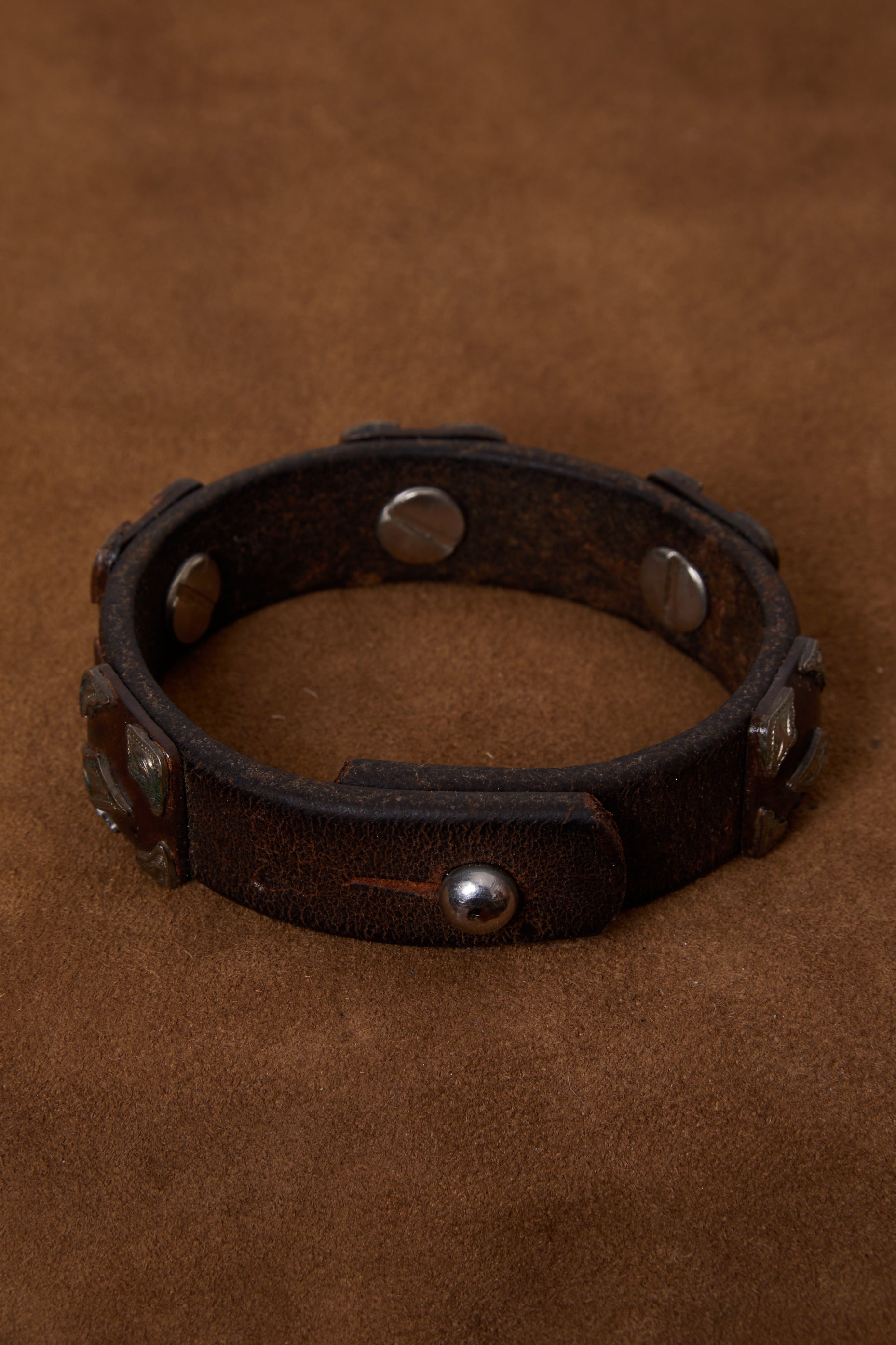 WEATHERED DARK BROWN LEATHER AND ORNATE SILVER BRACELET CUFF