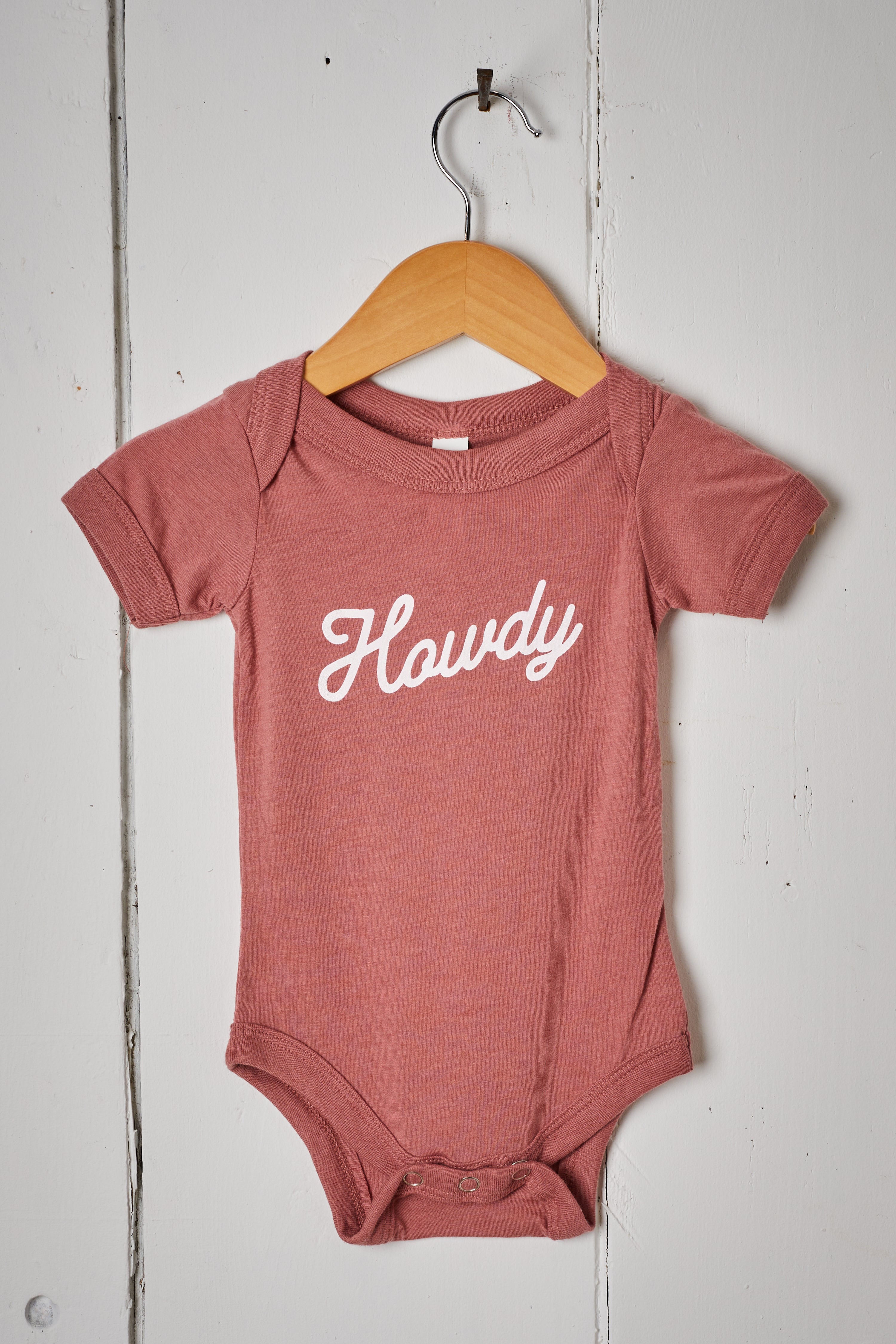 MAUVE HOWDY BABY ONESIE